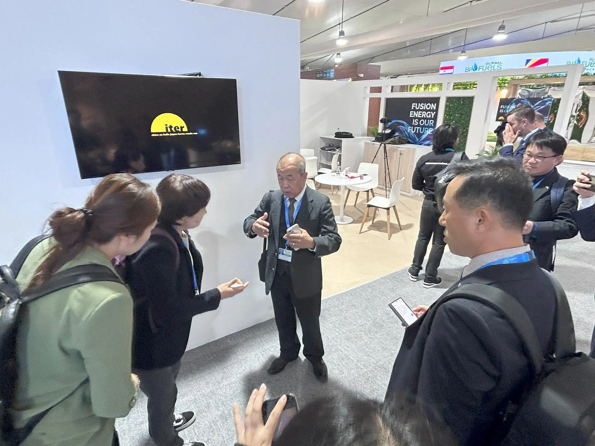 Delegations visiting the ITER booth at COP29